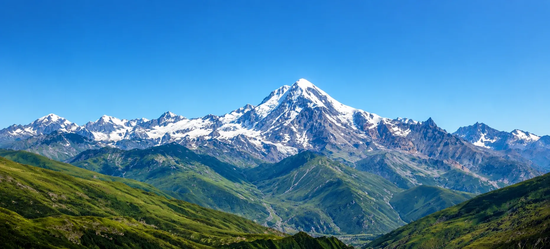 Mount Kazbek rising above Georgia's green Caucasus valleys